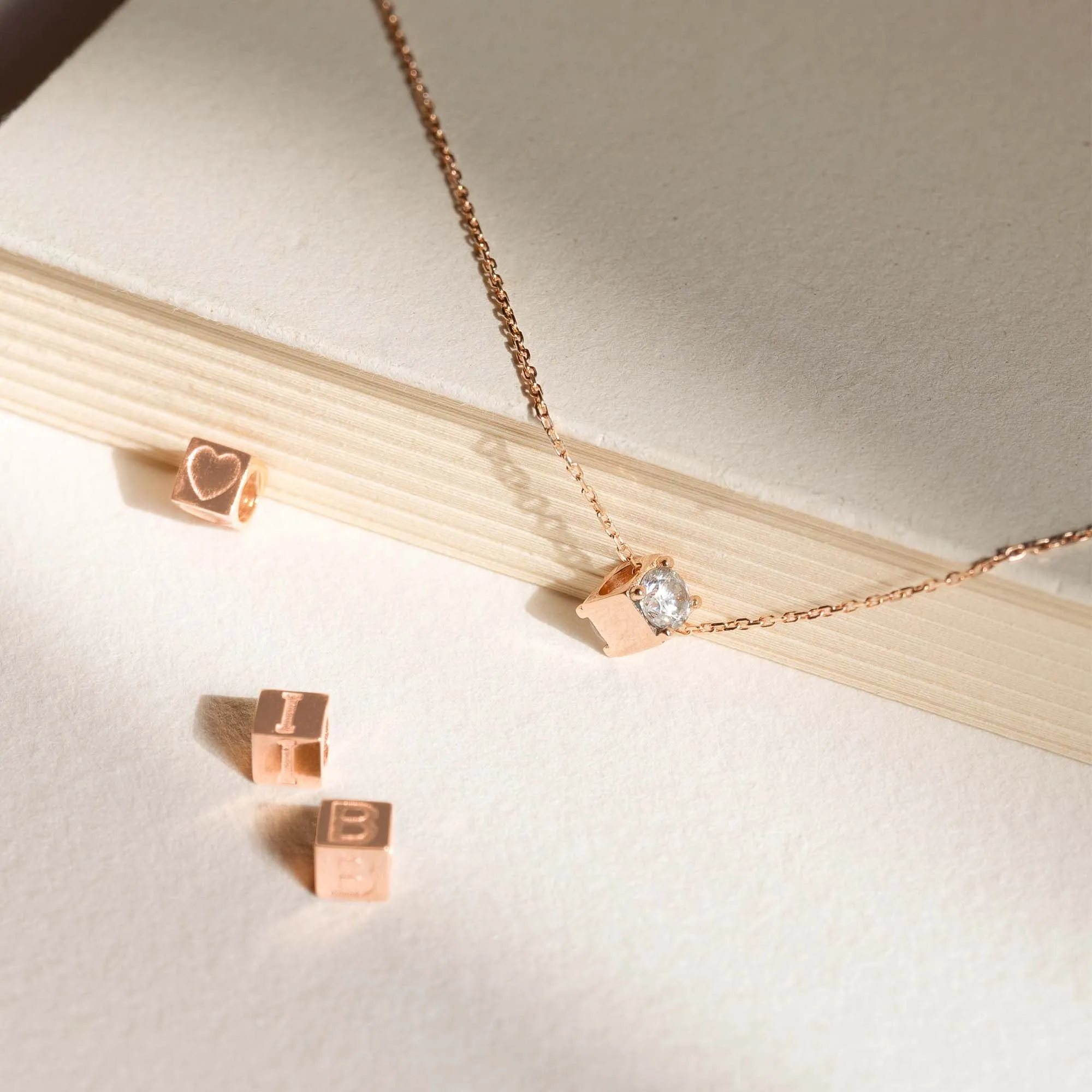 Cadeau d'Isabel 14 karat rose gold cube charm with heart and rose gold necklace gift set